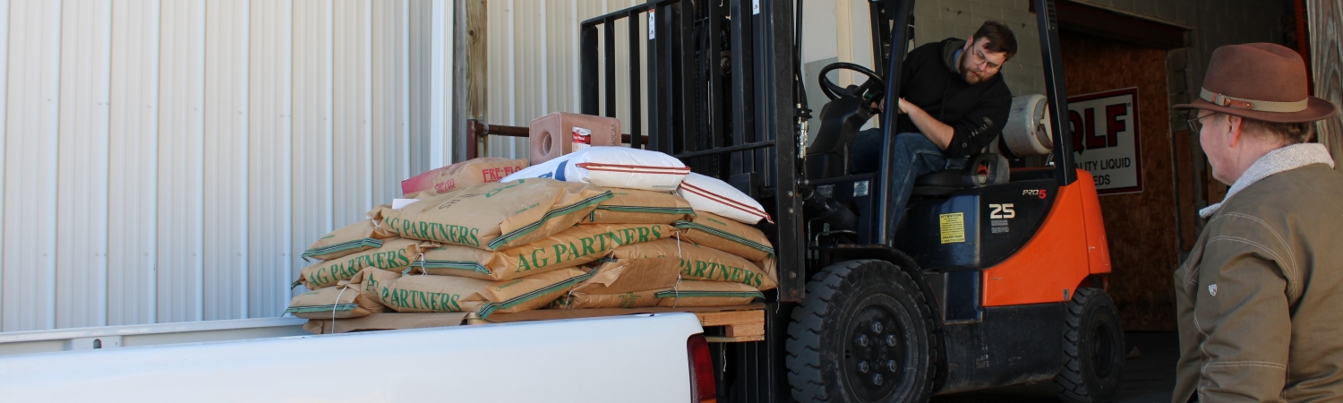 Forklift loading products into pickup truck