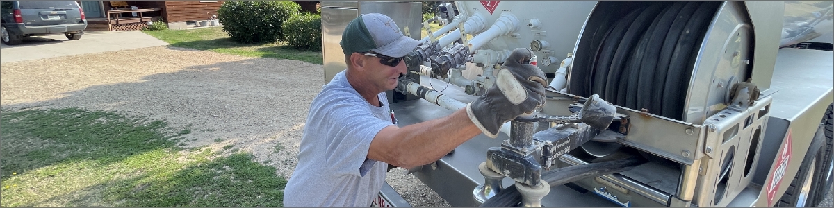 Man working on fuel truck.