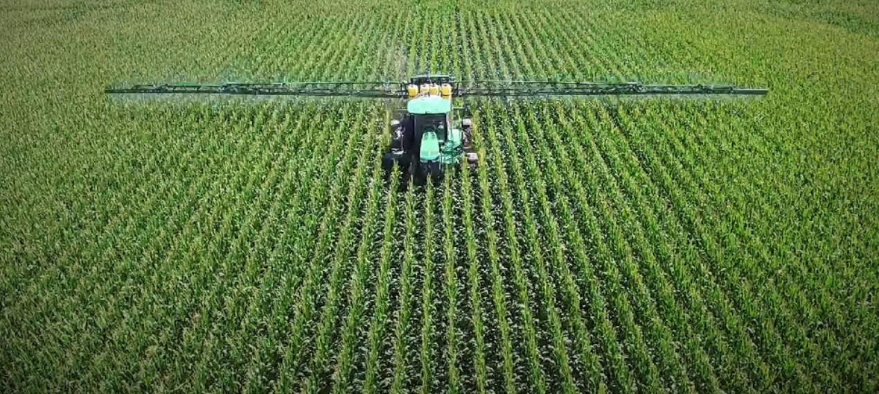 Tractor and sprayer in field